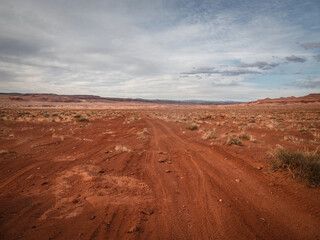 Fototapeta na wymiar Flat red desert sandy terrain near Moab Utah