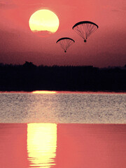 Paragliding at sunset. It is the recreational and competitive adventure sport of flying...