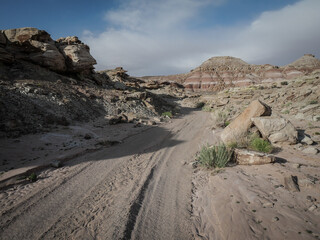 Sandy wash through colorful dirt bluffs and hills in Green River Utah near the Crystal Geyser