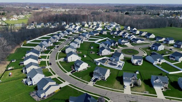 A slow orbiting aerial establishing shot view of a typical middle class Ohio residential neighborhood.  	