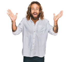 Handsome man with beard and long hair wearing casual clothes celebrating crazy and amazed for success with arms raised and open eyes screaming excited. winner concept