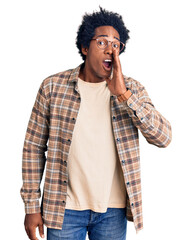 Handsome african american man with afro hair wearing casual clothes and glasses hand on mouth...