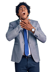 Handsome african american man with afro hair wearing business jacket shouting suffocate because...