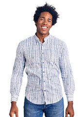 Handsome african american man with afro hair wearing casual clothes looking positive and happy...