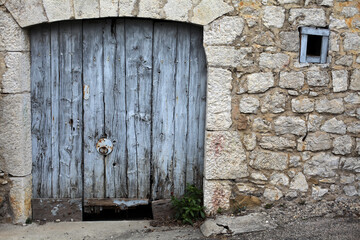 Old wooden painted gate and stone wall - Balazuc - Ardeche - France