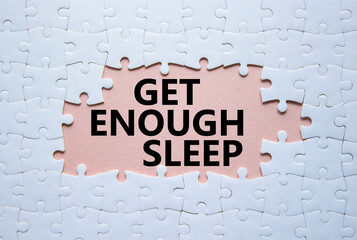Get enough sleep symbol. White puzzle with words Get enough sleep. Beautiful pink background....