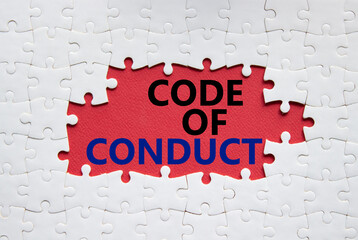 Code of conduct symbol. White Puzzle with words Code of conduct. Beautiful red background. Business and Code of conduct concept. Copy space.