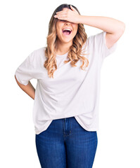Fototapeta premium Young caucasian woman wearing casual clothes smiling and laughing with hand on face covering eyes for surprise. blind concept.