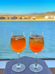 Two glasses of Aperol Spritz on the table of a lounge in a cruise ship