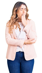 Young caucasian woman wearing business clothes bored yawning tired covering mouth with hand....