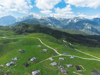 Aerial View of Mountain Cottages on Green Hill of Velika Planina Big Pasture Plateau, Alpine Meadow Landscape, Slovenia - 780822820