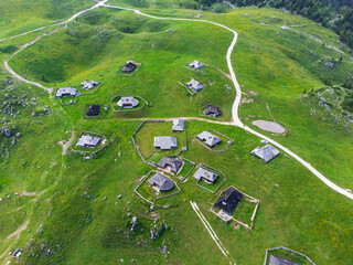 Aerial View of Mountain Cottages on Green Hill of Velika Planina Big Pasture Plateau, Alpine Meadow Landscape, Slovenia - 780822841