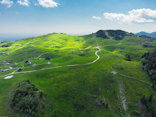 Aerial View of Mountain Cottages on Green Hill of Velika Planina Big Pasture Plateau, Alpine Meadow Landscape, Slovenia - 780822897