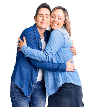 Couple of women wearing casual clothes hugging oneself happy and positive, smiling confident. self love and self care