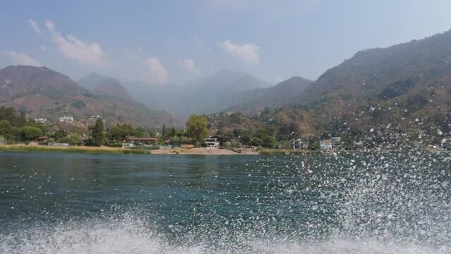 View of the shore of lake atitlan guatemala from a boat 