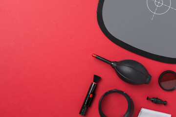 Different camera equipment and products on color background, top view