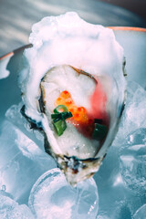 Fresh Oyster Topped With Roe and Chives Served on a Bed of Ice
