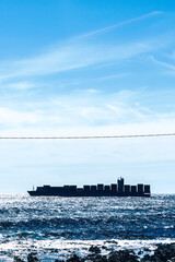 Large Cargo Ship Sailing on the Open Sea During a Clear, Sunny Day