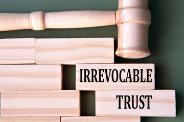 IRREVOCABLE TRUST - words on wooden blocks on a white background with a judge's gavel.