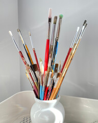 Paint brushes, spatula, pencil and artist material in a studio. Art supplies. Creative tools.