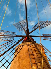 view of windmill on the Sicilian coast in Marsala, Italy