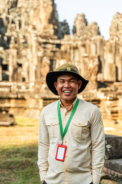 Cambodian guide smiling at Angkor Wat temple complex