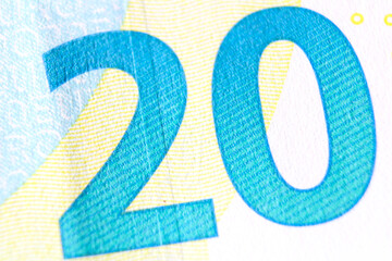 Close-up of a 20 euro banknote fragment on the reverse side, showing the denomination - number 20 . Macro photography. - obrazy, fototapety, plakaty