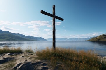 a cross on the shore of a lake