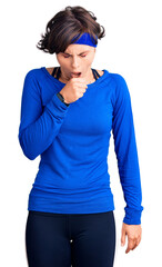 Beautiful young woman with short hair wearing training workout clothes feeling unwell and coughing as symptom for cold or bronchitis. health care concept.