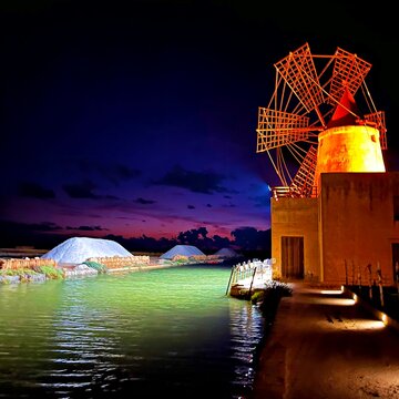 night view of the windmill inside the Ettore and Infersa salt pans company in Marsala, Sicily, Italy