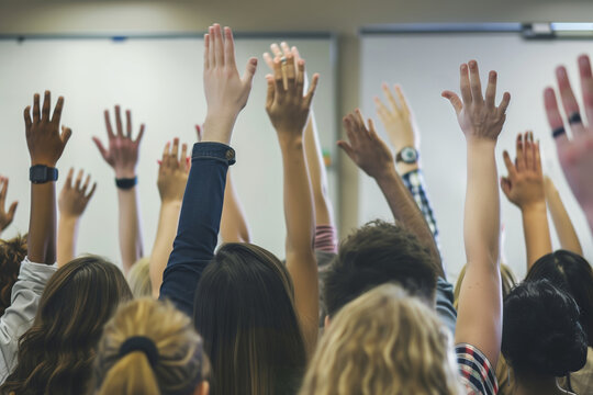 A classroom full of students eagerly raising their hands to answer or ask questions, showcasing engagement and participation