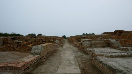 Ancient ruins pathway under overcast sky Mohenjo Daro