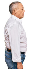 Handsome senior man wearing elegant white shirt looking to side, relax profile pose with natural...