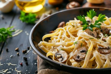 Traditional Italian homemade fettuccine pasta with mushrooms and cream sauce Fettuccine al Funghi Porcini served on a dark table with rustic wooden