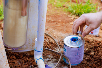 Glue is applied to pipe before it is glued by plumber