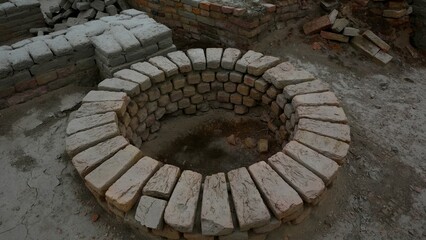 Partially built circular pit made of bricks in an under-construction setting Mohenjo Daro