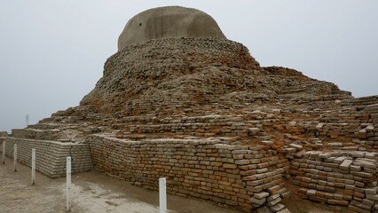 Weathered remains of a buddhist stupa, showcasing historical architecture and archaeology Mohenjo...