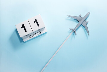 August calendar with number  11. Top view of a calendar with a flying passenger plane. Scheduler....