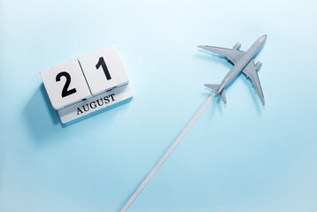 August calendar with number  21. Top view of a calendar with a flying passenger plane. Scheduler....