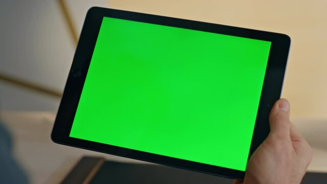 Man hands swiping mockup tablet at home closeup. Manager using chromakey device