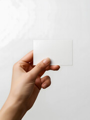 Human Hand Holding a Blank White Card Isolated on White Background