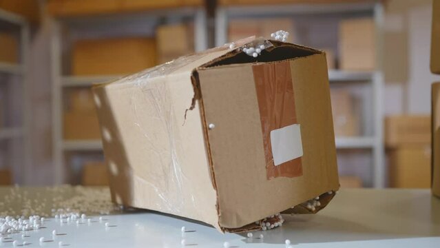loses damaged cardboard parcel in the warehouse close up