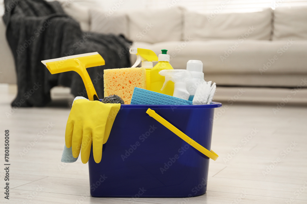 Canvas Prints Different cleaning supplies in bucket on floor at home