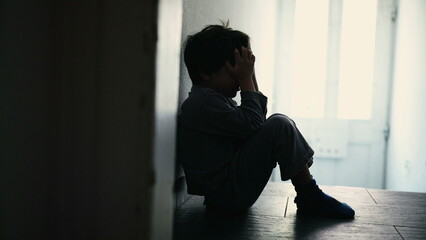Small Child Covering Face Feeling Despair One Small Boy Sitting In Dark Hallway Corridor At Home...