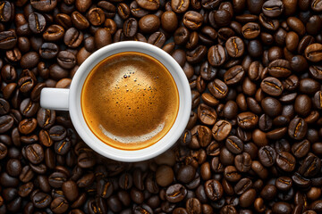 Fototapeta premium Freshly Brewed Coffee in a Black Cup Surrounded by Coffee Beans