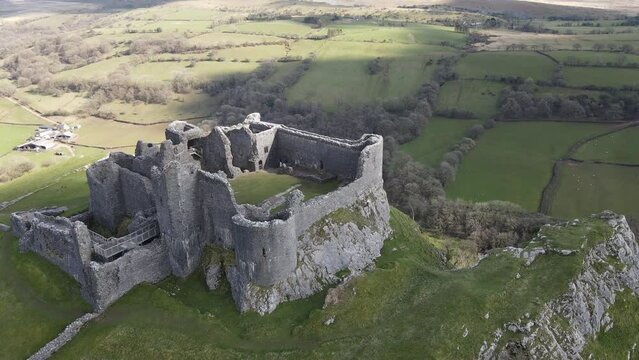 Drone shot of Carreg Cennen Castle overlooking the River Cennen, Wales, UK