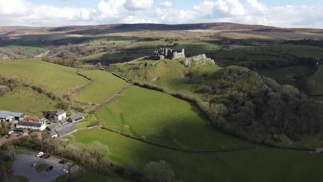 Aerial view of Carreg Cennen Castle on a rocky outcrop in Brecon Beacons National Park, Wales, UK