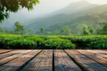 Wooden desk table with mountain view and tea plantation background copy space for text