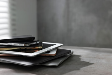 Naklejka premium Many different modern gadgets on grey table indoors. Space for text