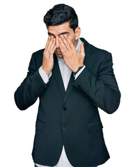 Handsome hispanic man wearing business clothes rubbing eyes for fatigue and headache, sleepy and...